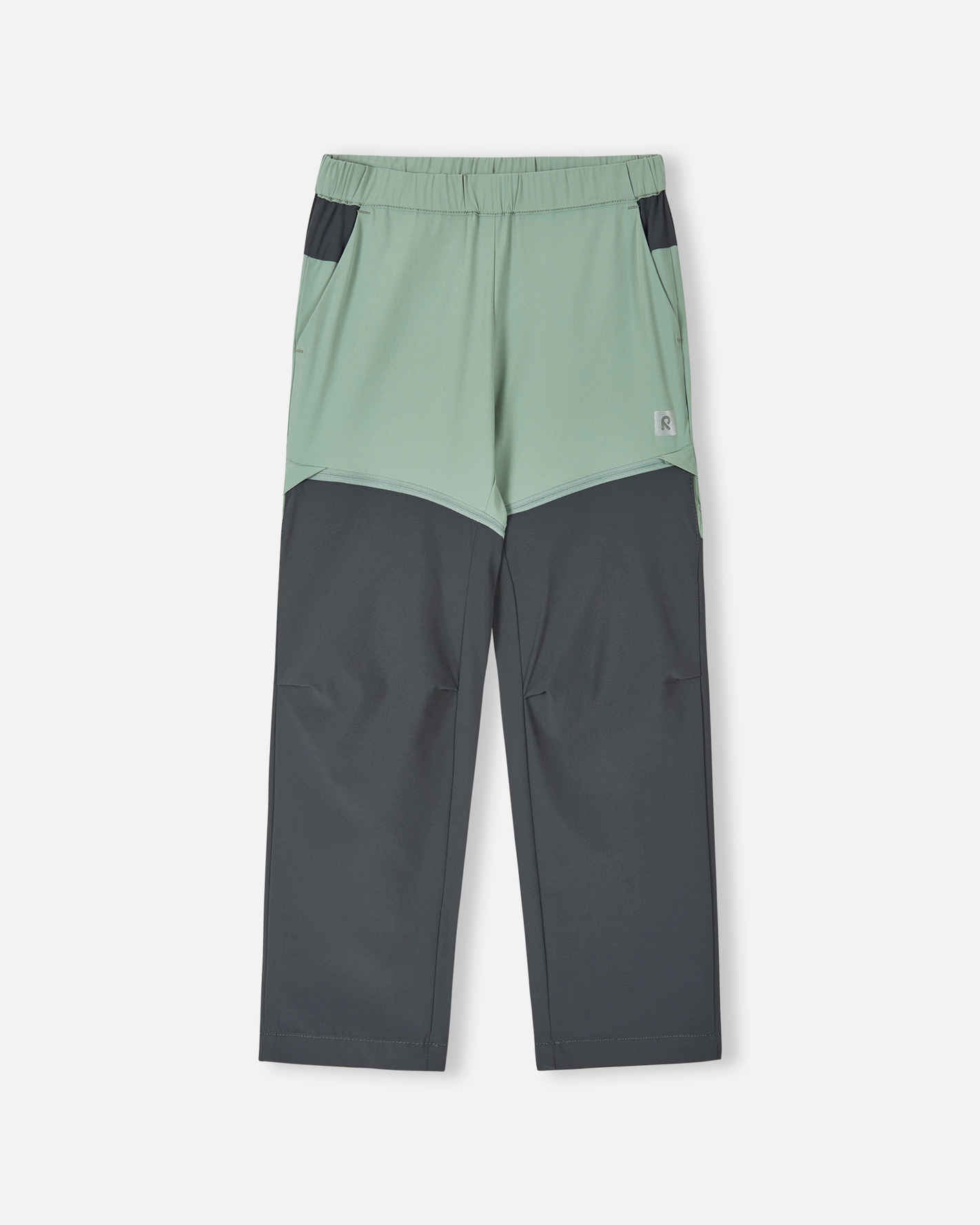 Front view of the Reima Kaveris kids' convertible hiking pants in stone green, featuring dark grey reinforced knee panels, an elastic waistband, and hidden zippers that convert the pants into shorts