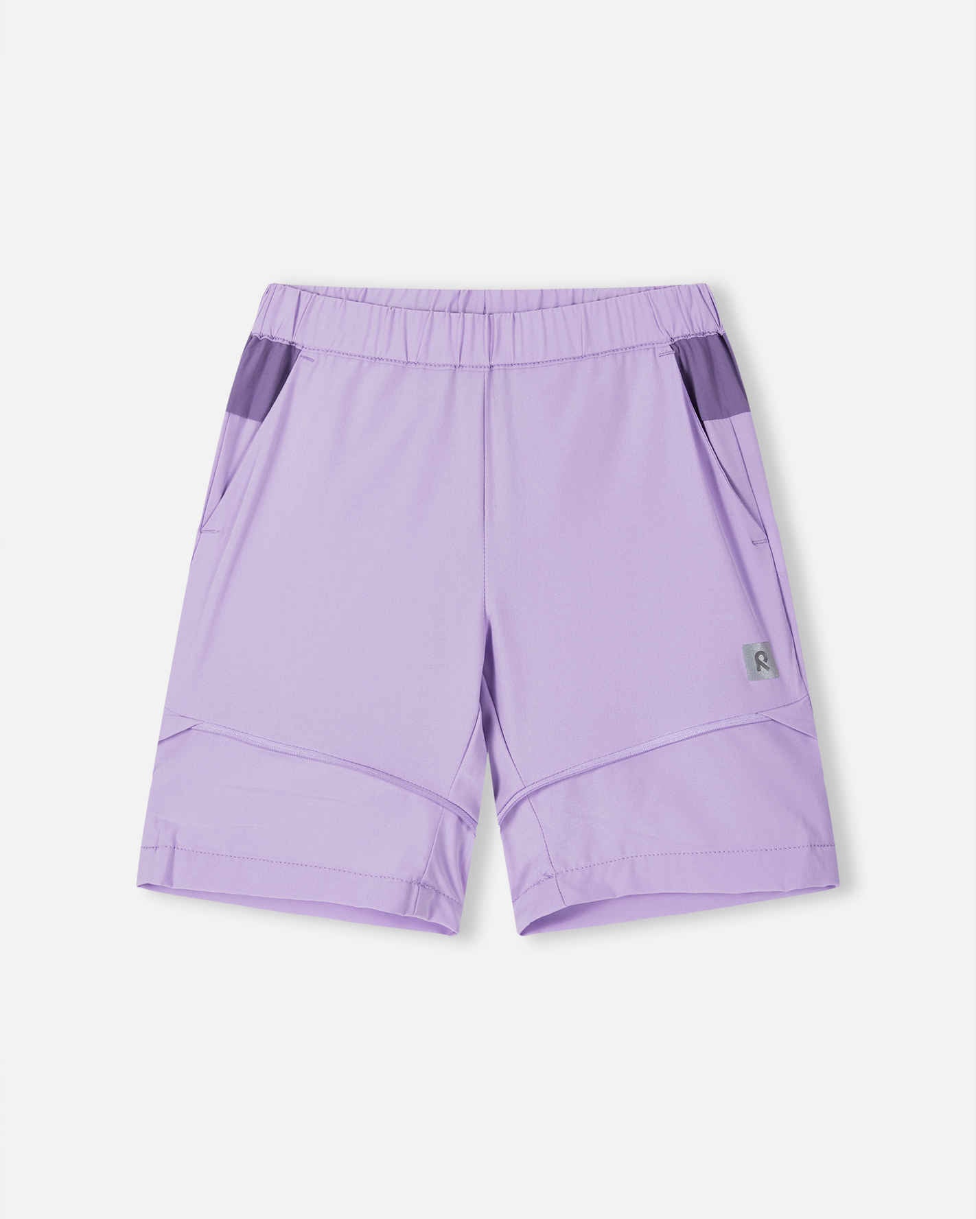 Front view of the Reima Kaveris kids' hiking pants converted into blooming lilac shorts, showing the light purple upper section, comfortable elastic waist, and clean zip-off hem ideal for warm weather hikes.