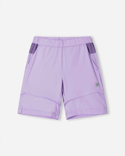 Front view of the Reima Kaveris kids' hiking pants converted into blooming lilac shorts, showing the light purple upper section, comfortable elastic waist, and clean zip-off hem ideal for warm weather hikes.