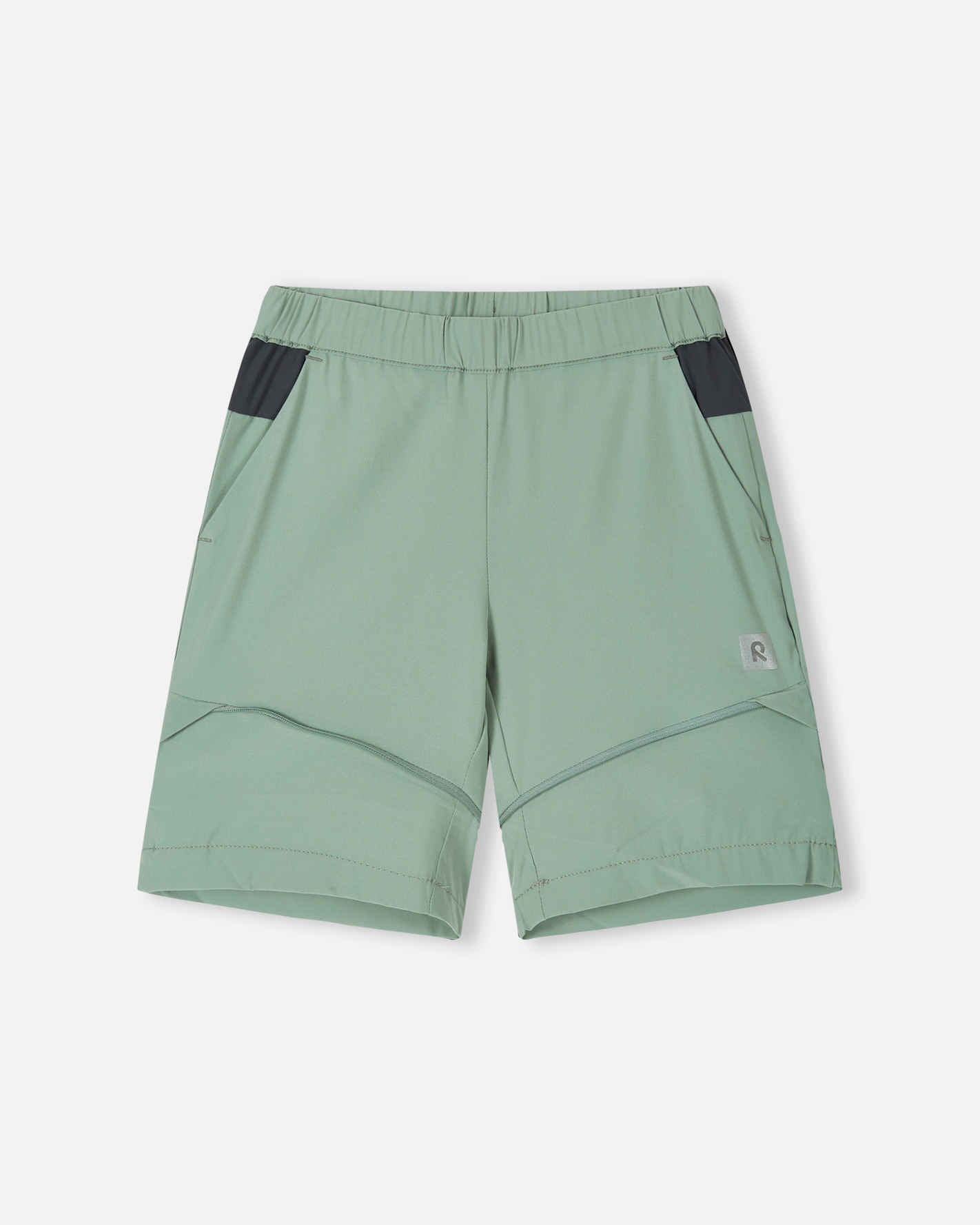 Front view of the Reima Kaveris kids' hiking pants converted into stone green shorts, demonstrating the versatile zip-off design, comfortable fit, and practical dark grey pocket details.