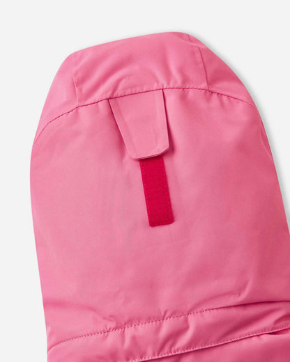 Close-up of the hook-and-loop velcro adjustment strap on the back of the soft coral Reima Kiiruna children's ski jacket hood, engineered to provide a customizable and secure fit over winter beanies.
