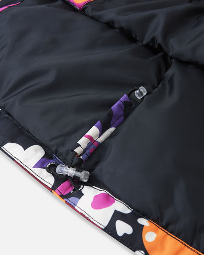 Close-up detail of the inner bottom hem on the Reima Kiiruna high-quality girls' winter ski jacket, featuring an adjustable elastic bungee cord and secure toggle lock designed to seal out cold drafts.