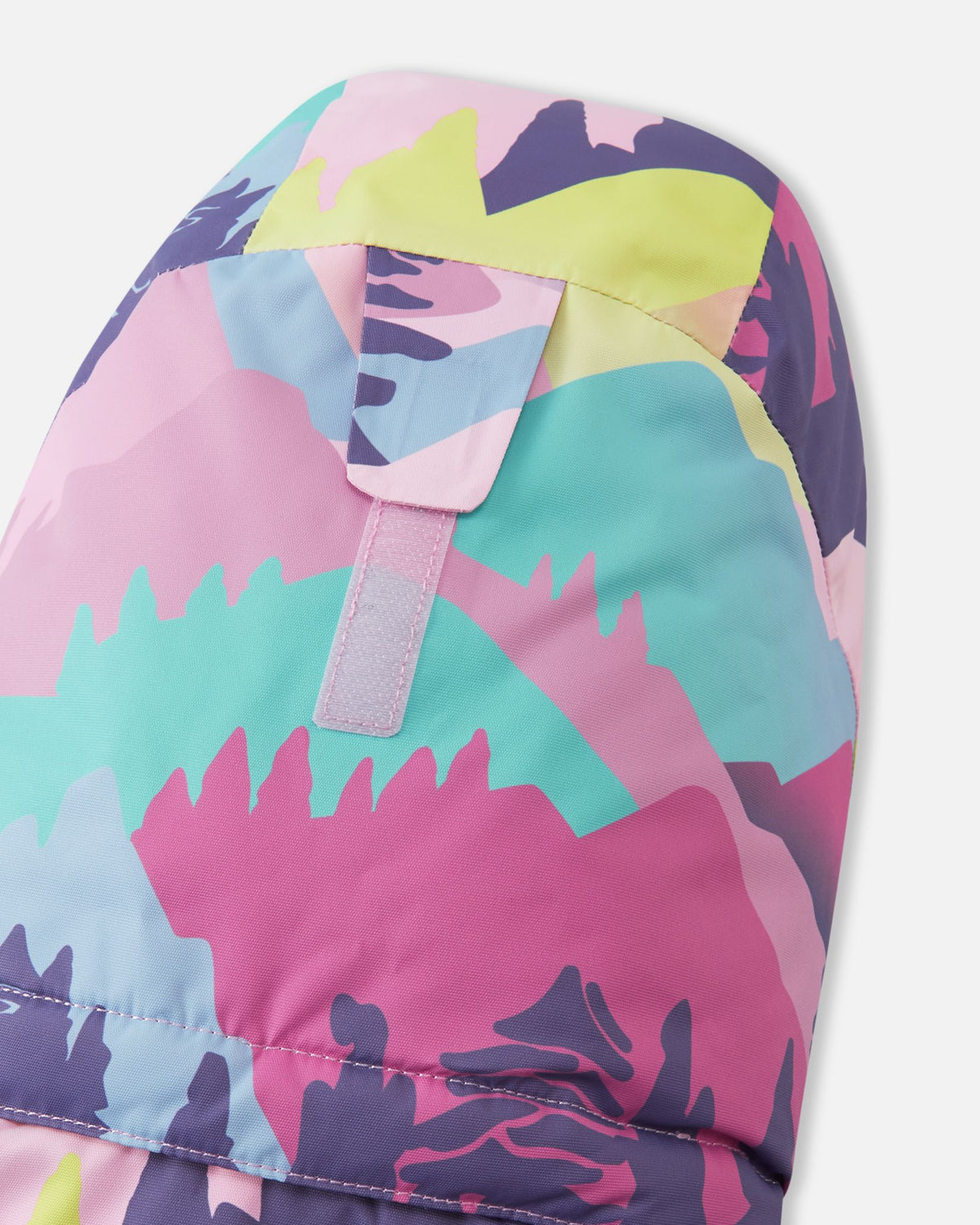 Close-up of the back of the hood on the Reima Kiiruna girls' ski jacket, featuring a Velcro adjustment tab designed to customize the fit, depth, and peripheral vision over a ski helmet or winter beanie.