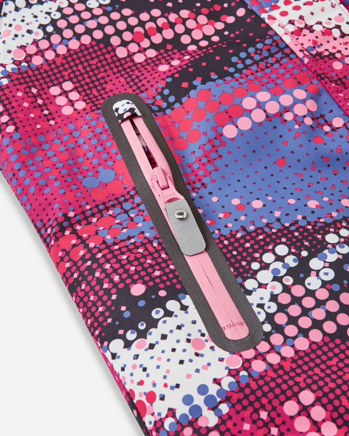 Close-up detail of the secure front zippered pocket on the rosy berry print Reima Kiiruna girls' ski jacket, featuring a bright pink water-resistant zipper track and a durable pull tab that is easy for kids to grip with winter gloves.