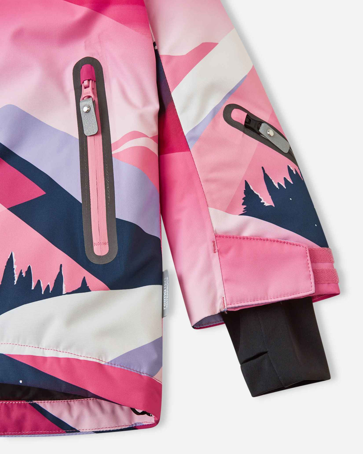 Detail shot of the lower body and sleeve on the soft coral Reima Kiiruna kids' snow coat, focusing on the slanted zippered hand pocket, adjustable outer cuff, and inner lycra thumbhole wrist gaiter.