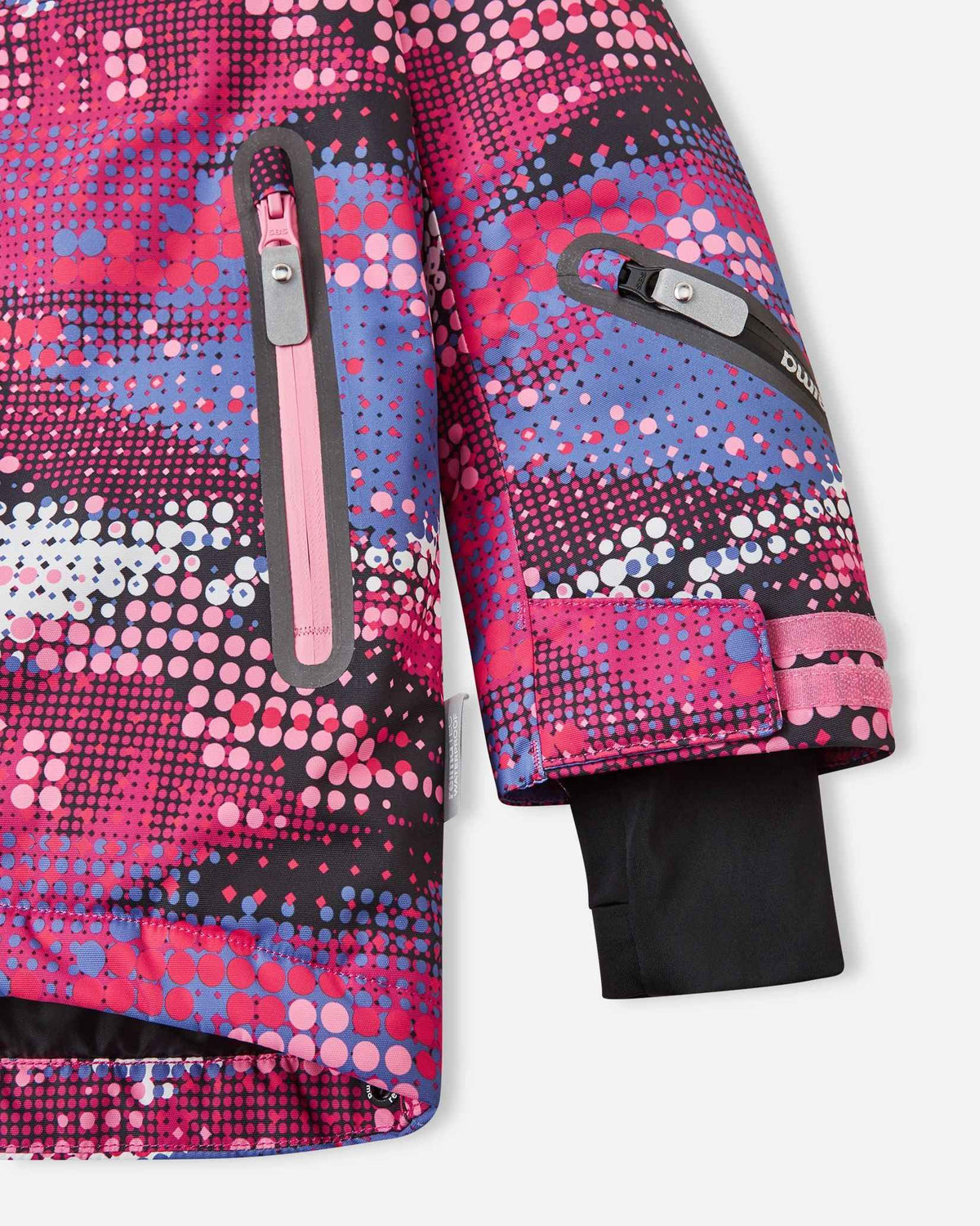 Detail view of the forearm and lower body on the rosy berry Reima Kiiruna kids' snow jacket, highlighting the zippered ski pass pocket, adjustable wrist strap, and inner thumbhole cuff gaiter.