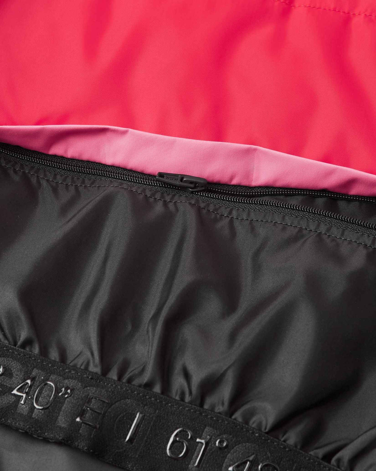 Close-up of the durable interior zipper attachment for the snow lock on the soft coral Reima Kiiruna kids' winter jacket, ensuring a secure, draft-proof seal against freezing wind and powder.
