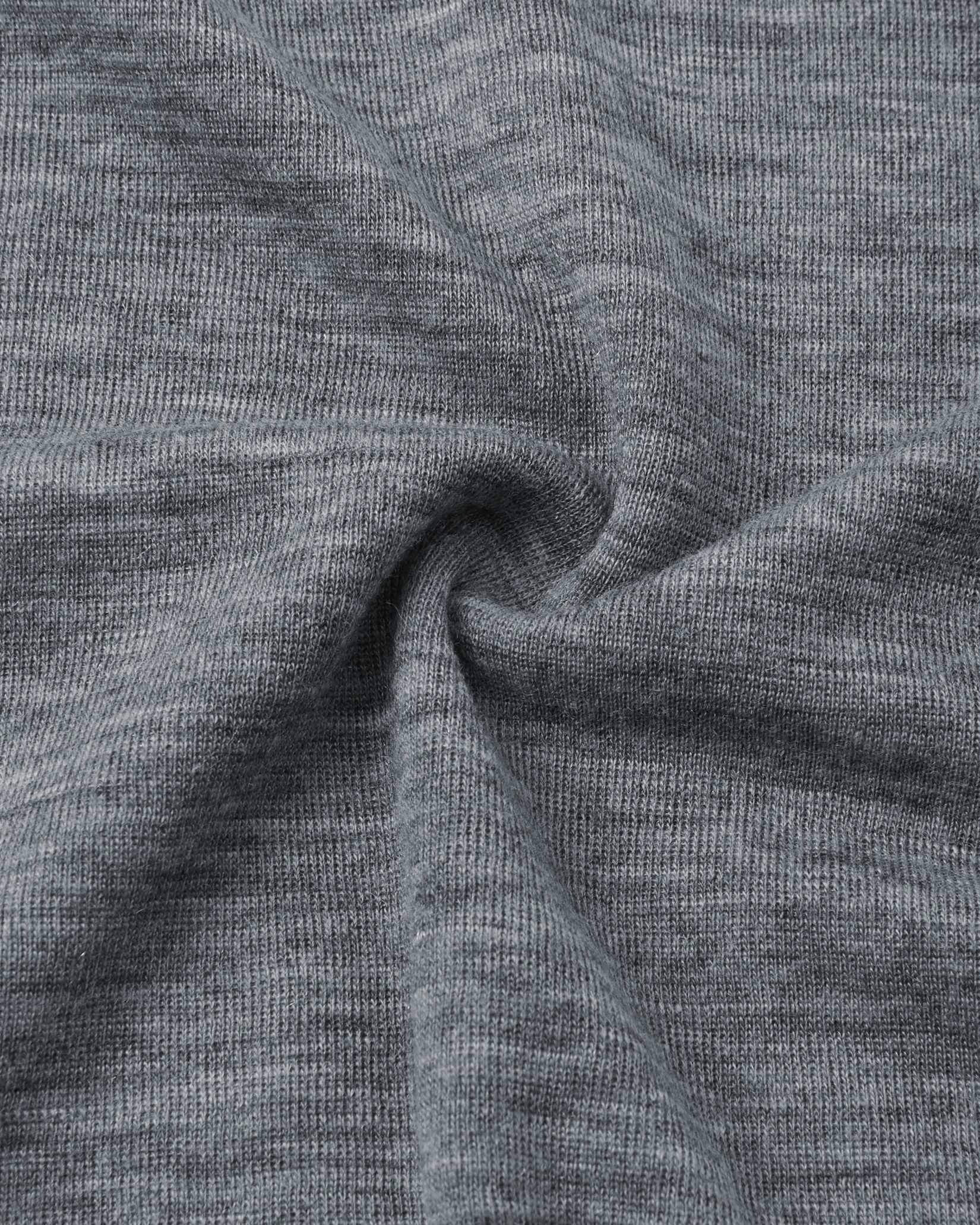 Close-up detail of the soft, melange grey merino wool knit fabric used in the Reima Kinsei kids' thermal base layer set.