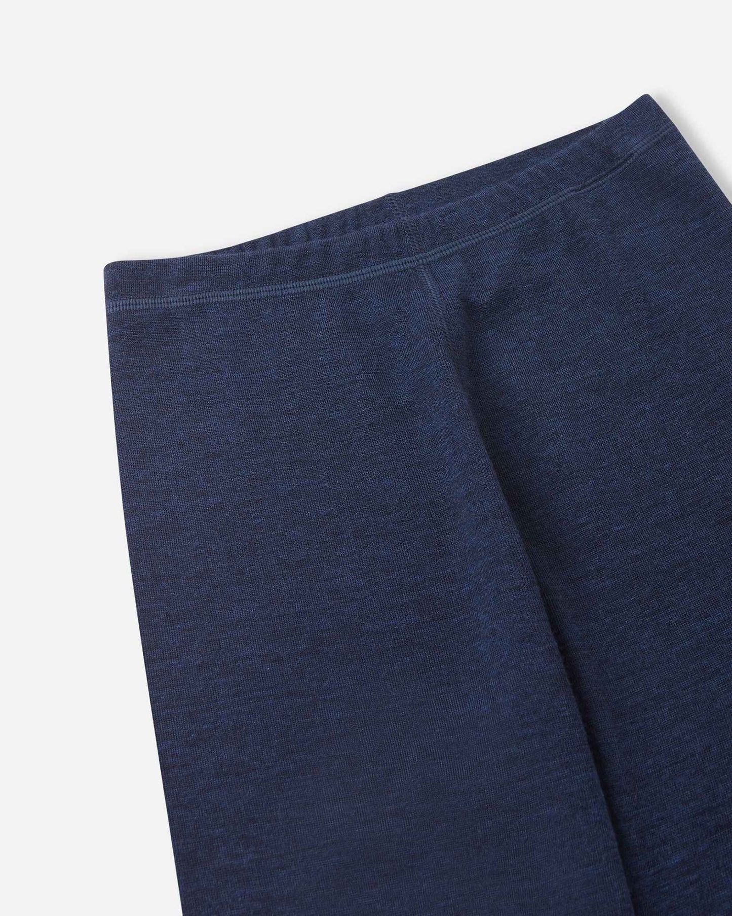 Detailed close-up of the elastic waistband on the navy blue merino wool base layer leggings from the Reima Kinsei set, highlighting the soft fabric and construction.