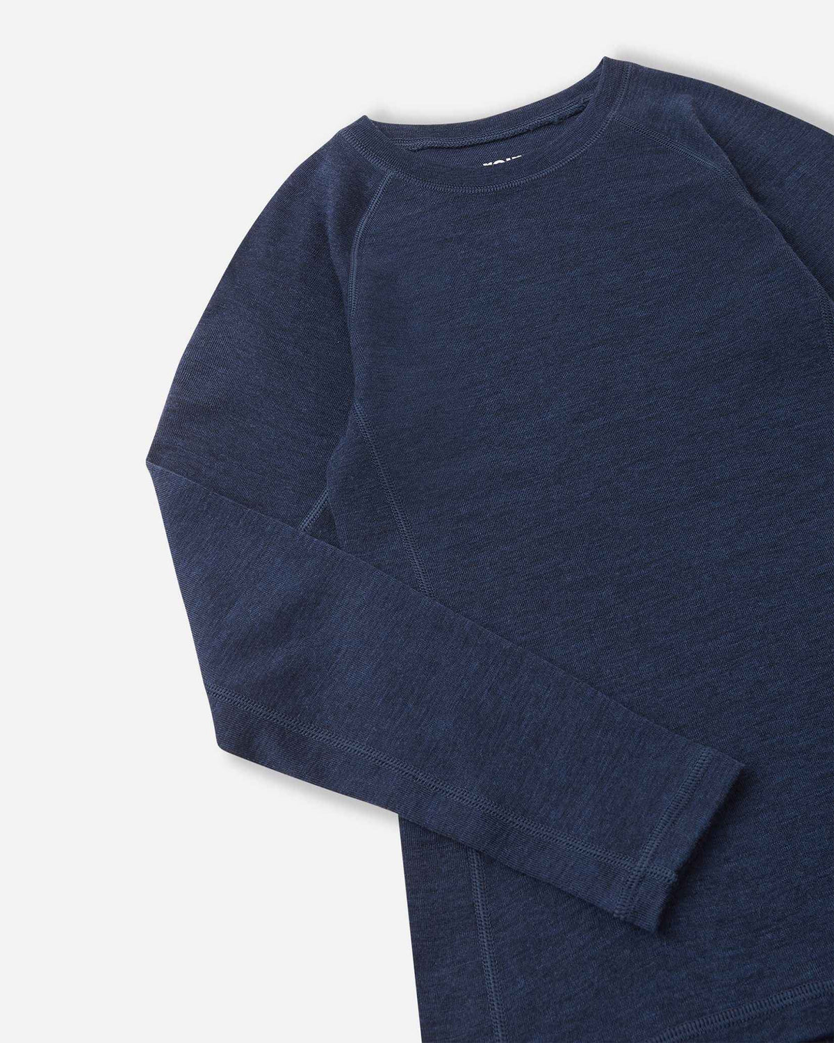Detailed close-up shot of the navy blue merino wool base layer top from the Reima Kinsei set, showing the texture of the fabric, flat-lock stitching on the shoulder, and sleeve cuff.