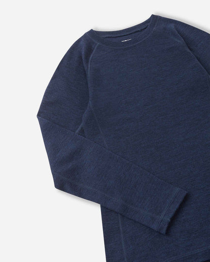 Detailed close-up shot of the navy blue merino wool base layer top from the Reima Kinsei set, showing the texture of the fabric, flat-lock stitching on the shoulder, and sleeve cuff.