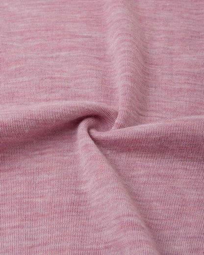 Detailed macro close-up of the grey pink knitted merino wool fabric used in the Reima Kinsei kids' base layer set, swirled to display its soft and warm texture.