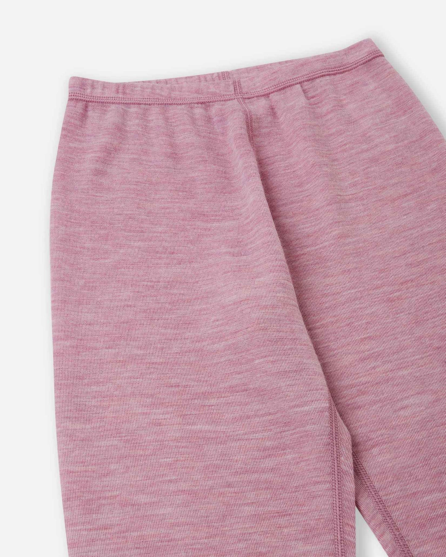 Detailed close-up of the elastic waistband and soft knit fabric on the Reima Kinsei kids' merino wool base layer leggings in grey pink.