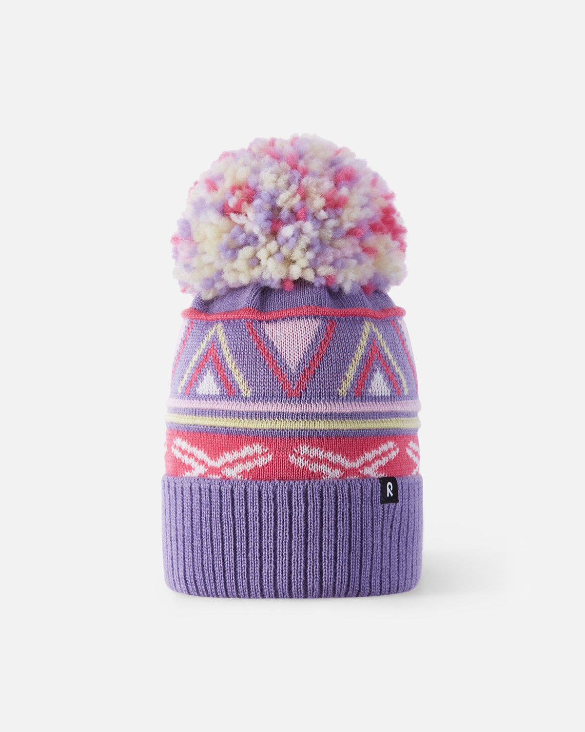 Front flat lay view of the blooming lilac Reima Kirjoen kids' merino wool beanie. The image highlights the colorful geometric jacquard knit pattern, a wide ribbed fold-up hem, and a matching multi-colored yarn pom-pom on top.