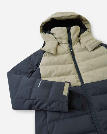 Close-up of the upper half of the Reima Kuosku kids ski jacket in Soft black, detailing the high protective collar, main front zipper, and adjustable velcro cuffs with inner lycra sleeves.