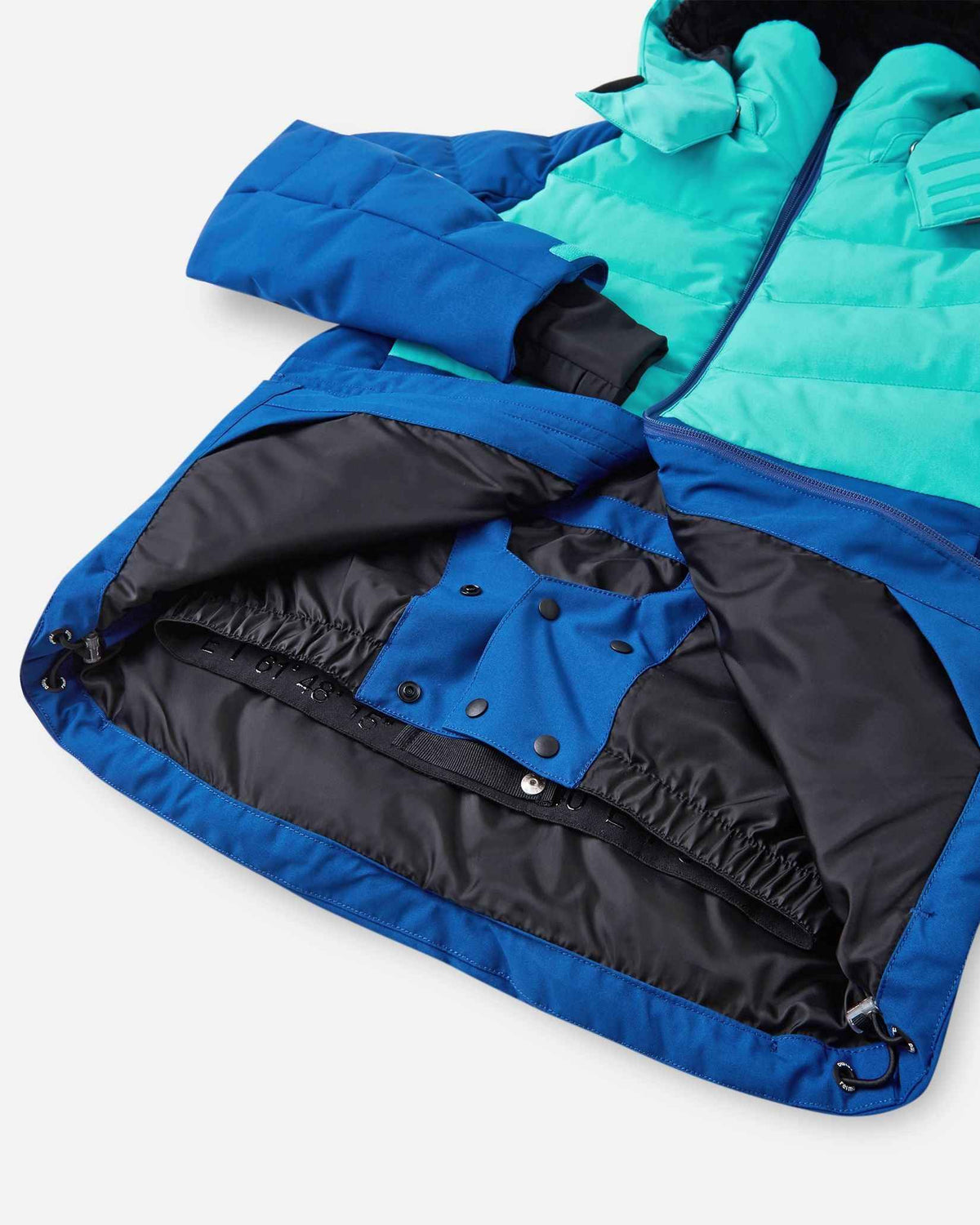 Interior view of the lower half of the Reima Kuosku kids ski jacket in twilight blue, detailing the built-in snow skirt with snap fasteners and an elastic grip band designed to block out snow and cold drafts during winter sports.