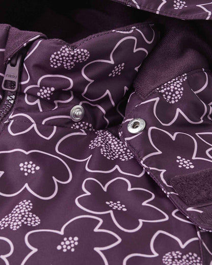 Detail shot of the collar area on the deep purple Reima Kurikka snowsuit, revealing the child-safe detachable hood snap fasteners and a plush inner fleece lining for neck warmth.