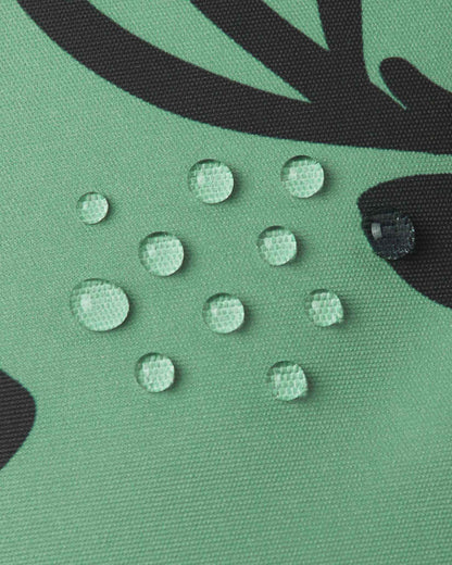 Close-up of water droplets beading on the green clay Reima Kurikka fabric, demonstrating its waterproof and dirt-repellent surface.
