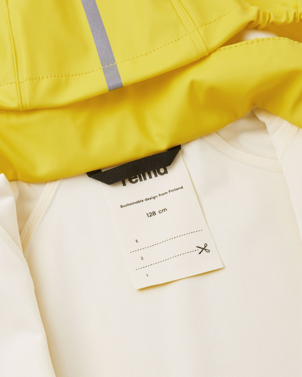 Close-up of the interior collar of the Reima Lampi yellow raincoat, showing a sturdy black hanging loop and a practical name tag space for easy identification at school or daycare.