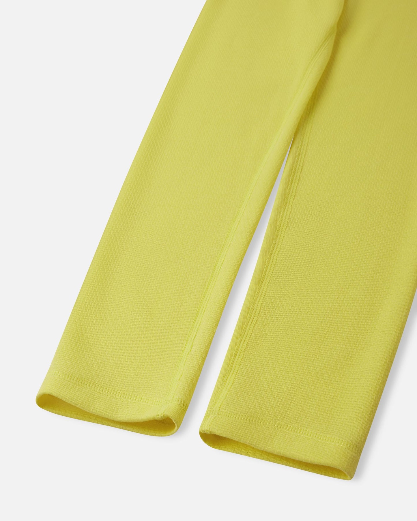 Close-up of the sleeve and ankle cuffs showing the durable flatlock stitching on the yellow Reima Lani kids' thermal base layer apparel.