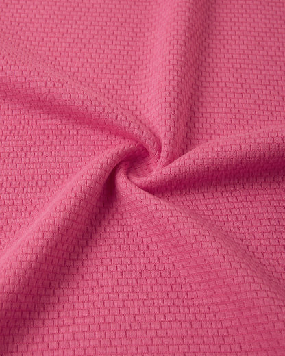 Close-up texture view of the soft, insulating Thermolite material used in the soft coral Reima Lani kids' base layer set for superior warmth and breathability.