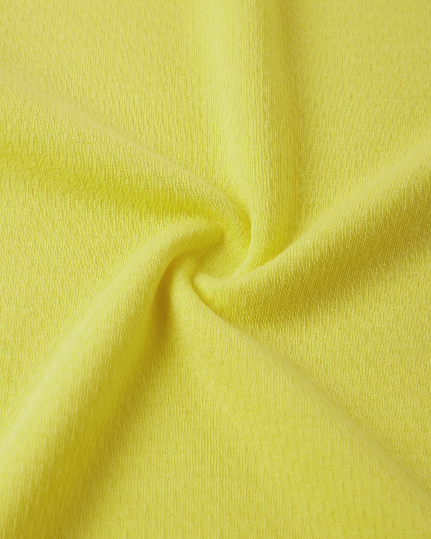Close-up texture view of the soft, insulating Thermolite material used in the yellow Reima Lani kids' base layer set for superior warmth and breathability.