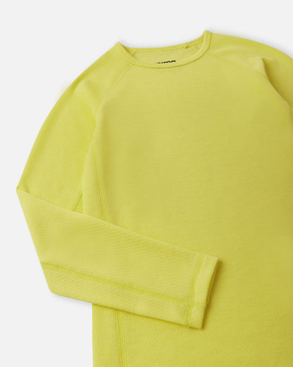 Close-up detail of the crew neck collar and raglan sleeve construction on the yellow Reima Lani kids' moisture-wicking thermal top.