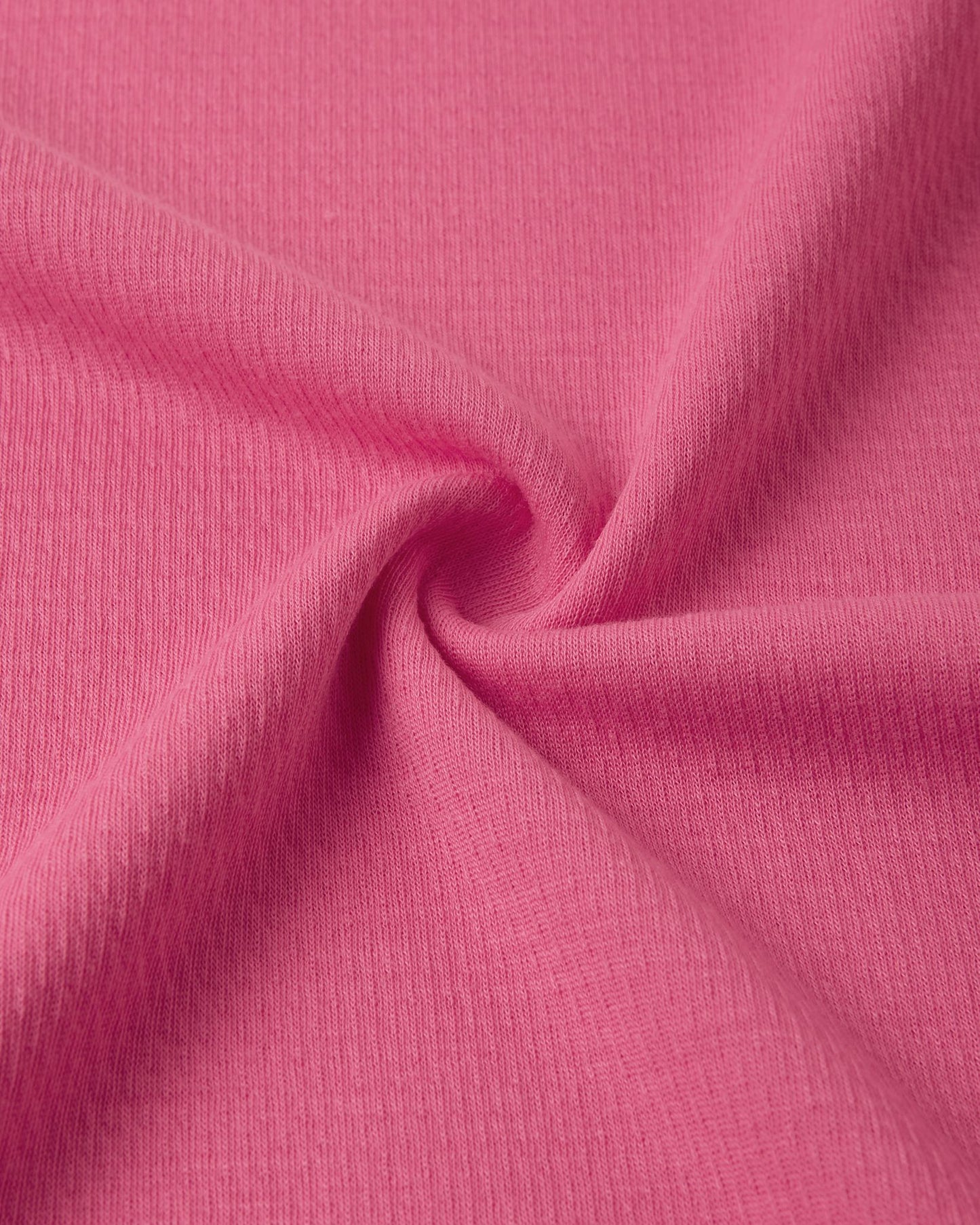Macro close-up of the technical knit fabric on the soft coral Reima Lani kids' Thermolite base layer, showing the specialized moisture-wicking grid structure.