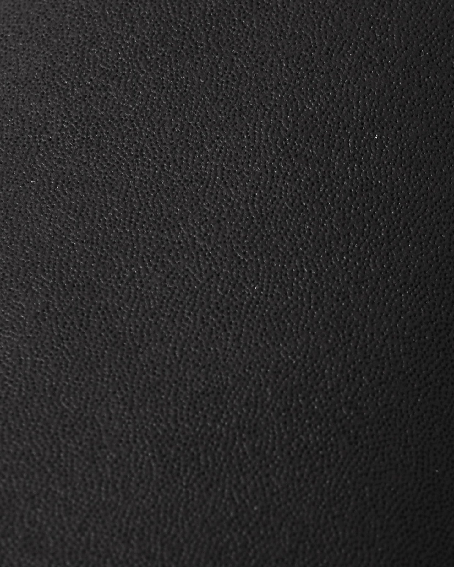 Macro close-up of the highly durable, textured black reinforced material used on the palms and thumbs of the Reima Lapases kids' ski mittens, engineered for superior abrasion resistance.