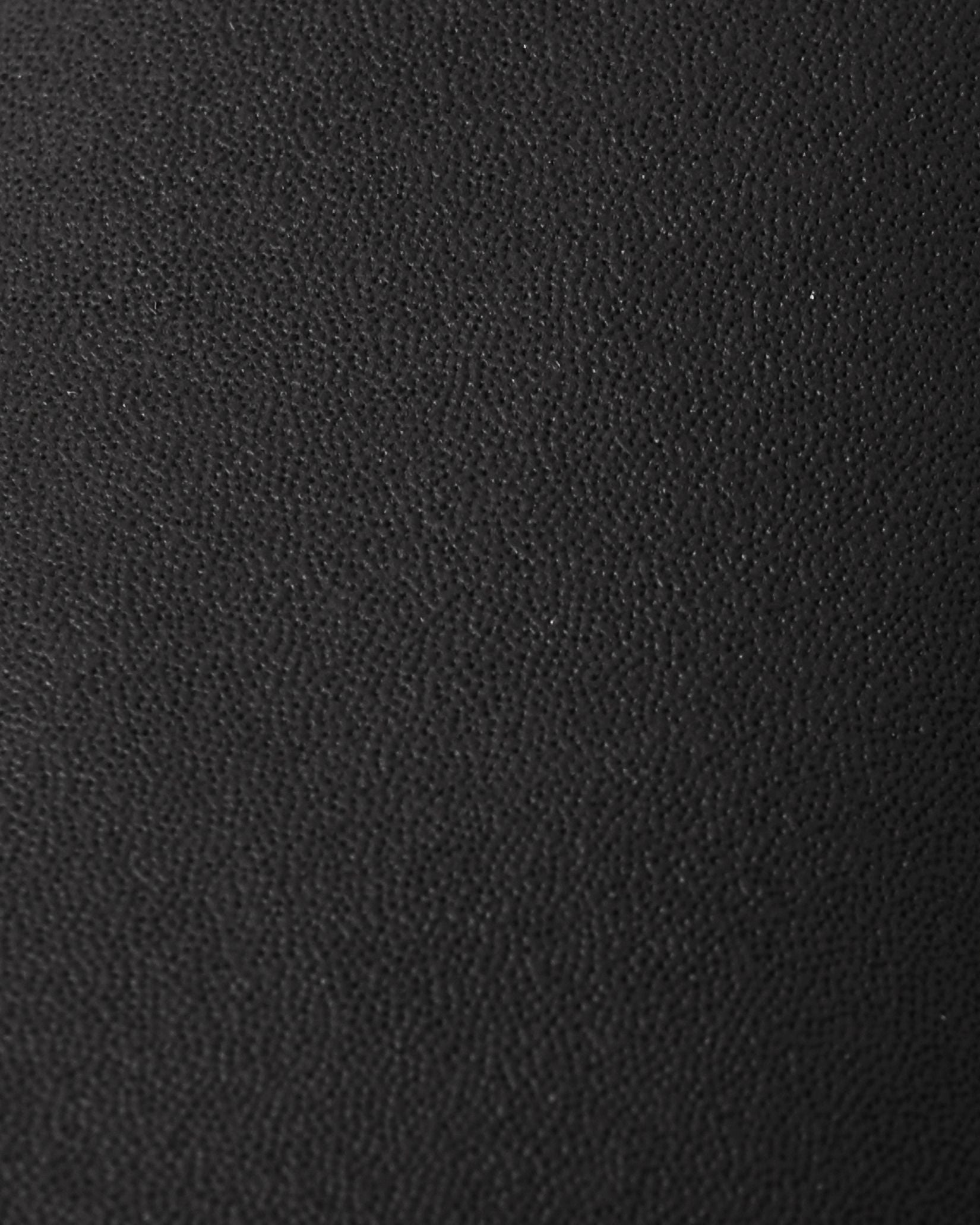 Macro close-up of the highly durable, textured black reinforced material used on the palms and thumbs of the Reima Lapases kids' ski mittens, engineered for superior abrasion resistance.