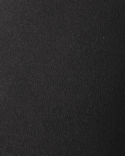 Macro close-up of the highly durable, textured black reinforced material used on the palms and thumbs of the Reima Lapases kids' ski mittens, engineered for superior abrasion resistance.