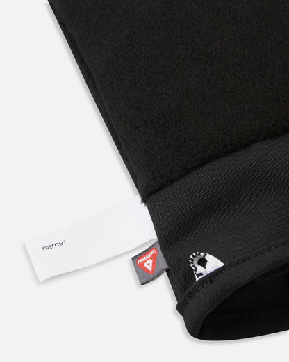 Detail of the inner cuff of the blooming lilac Reima Lapases kids' ski mittens, revealing the soft black thermal fleece lining, a blank customizable name tag, and the 100% recycled PrimaLoft insulation label for premium winter warmth.