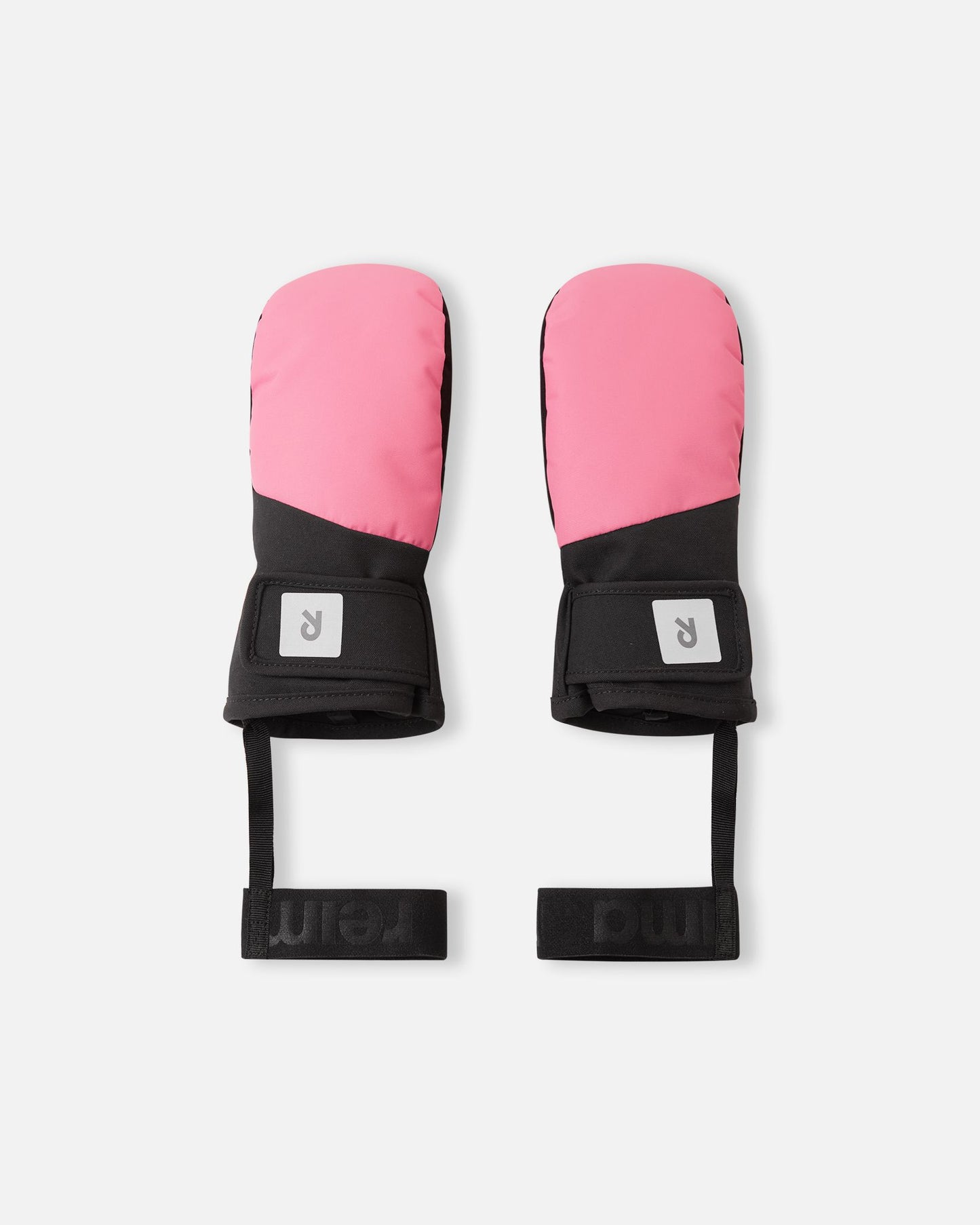 Flat lay view of the backs of the soft coral pink Reima Lapases kids' ski mittens. The image highlights the shorter wrist-length cuff, an adjustable hook-and-loop strap for a secure fit, and attached elastic safety wrist leashes.