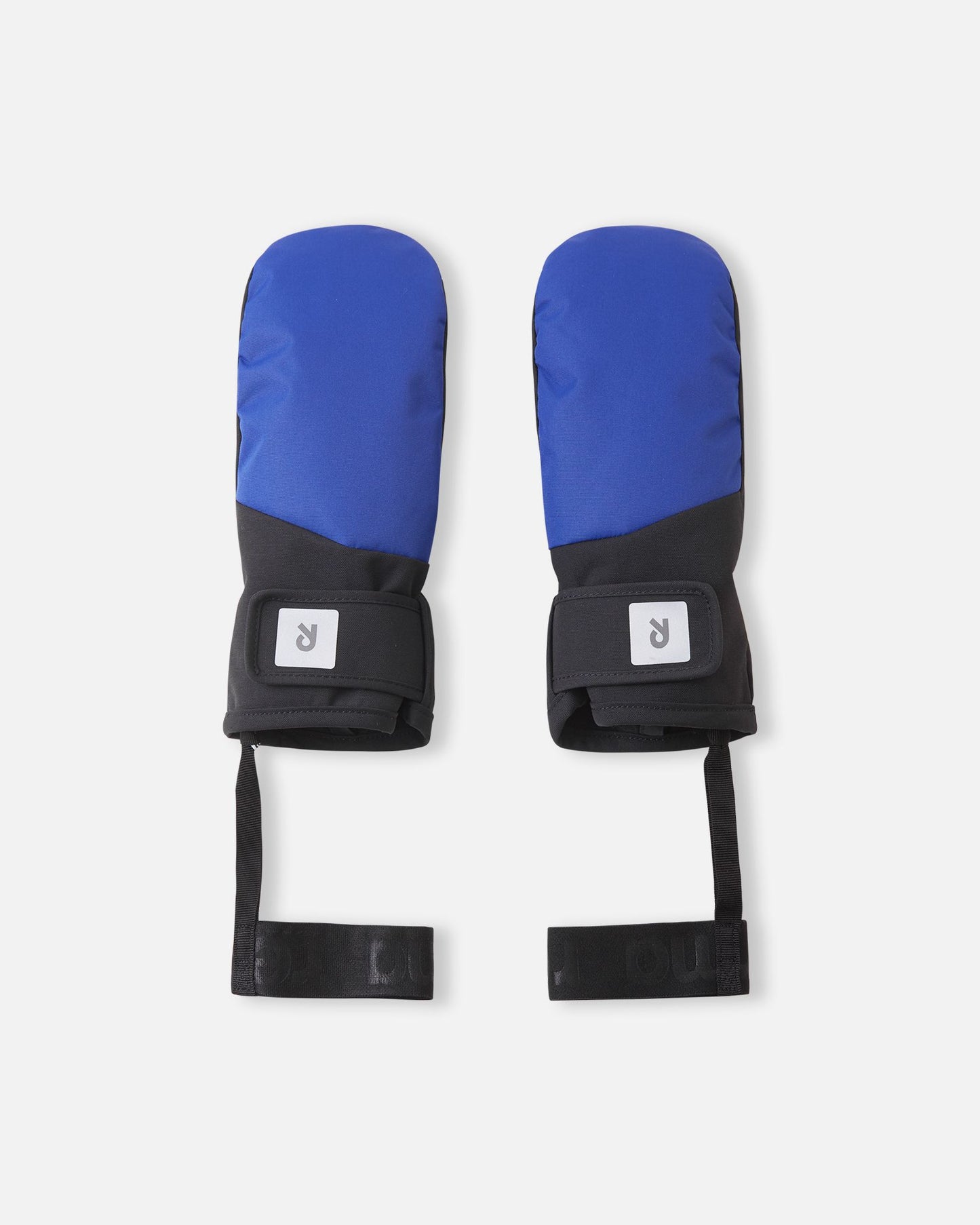 Flat lay view of the backs of the twilight blue Reima Lapases kids' ski mittens, featuring waterproof technical fabric, easy-to-use hook-and-loop adjustable wrist straps, and attached elastic safety wrist leashes.