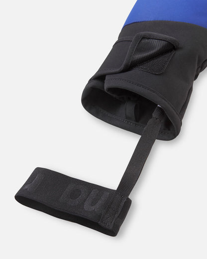 Close-up detail of the cuff opening on the twilight blue Reima Lapases kids' ski mittens, highlighting the wide hook-and-loop adjustment tab and the attached elastic safety wrist leash to keep gear securely in place.