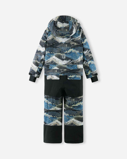 Full back view of the Reima Lappea kids' ski suit featuring a soft black and blue geometric pattern on the upper body and lower legs, highly durable solid black reinforced fabric on the seat and knees, and a reflective safety patch centered on the lower back.