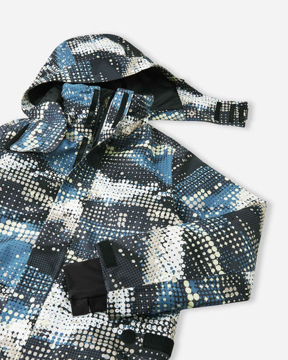 Upper front view of the Reima Lappea kids' winter ski suit showcasing the dynamic soft black, blue, and cream dot pattern, featuring a protective winter hood, a high wind-blocking collar, and a smooth, durable main zipper.