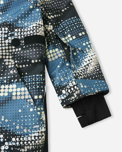 Detail shot of the Reima Lappea kids' ski suit sleeve, featuring a convenient zippered ski pass pocket on the forearm, an adjustable velcro outer cuff, and a cozy inner stretch lycra cuff with a thumb hole to lock out snow and cold drafts.
