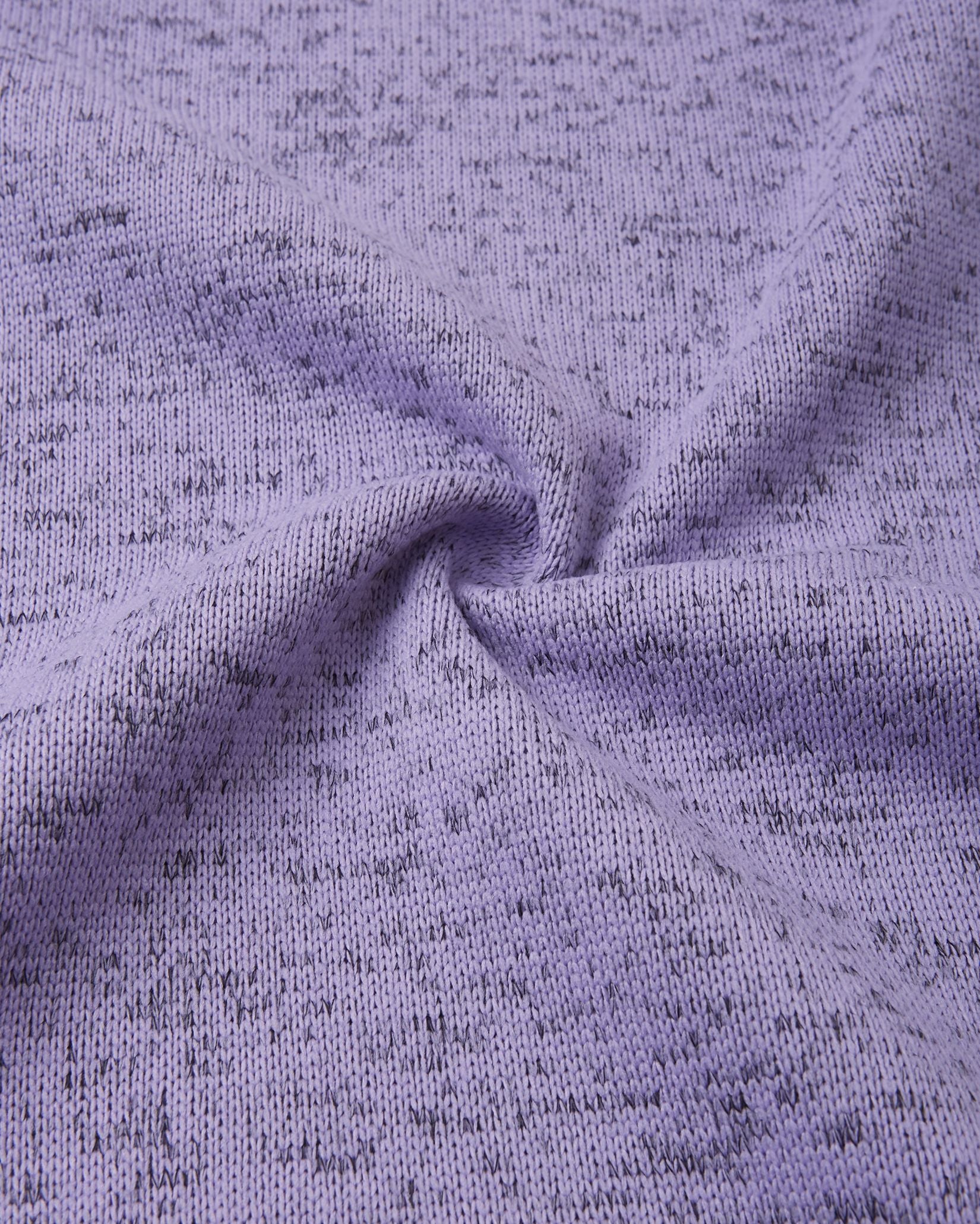 Macro close-up of the breathable, soft-brushed fleece knit fabric on the Reima Laskien kids' jacket, demonstrating its premium warmth and moisture-wicking properties.