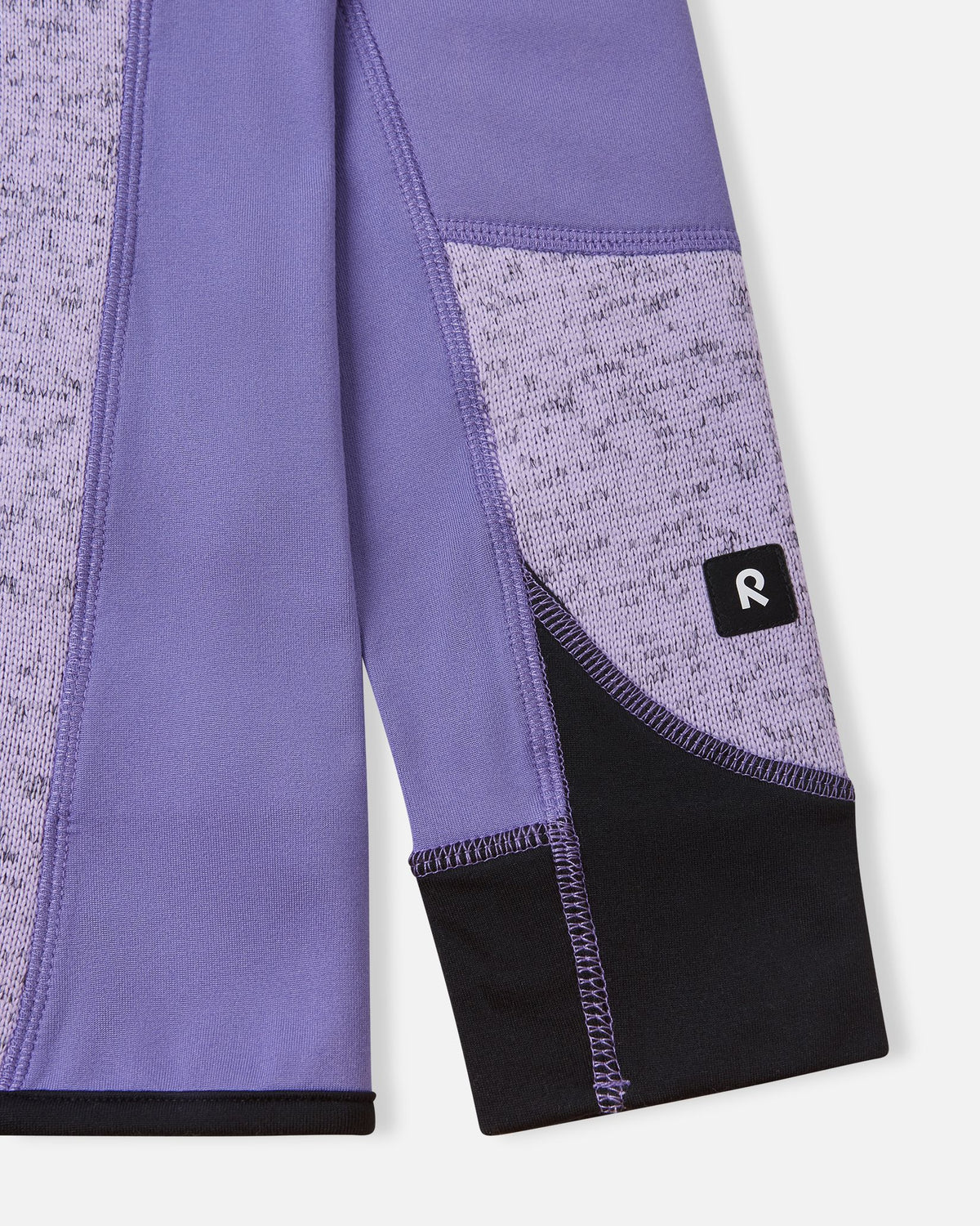 Detailed close-up of the reinforced sleeve cuff on the blooming lilac Reima Laskien kids' fleece jacket, showing high-quality stitching and the branded Reima logo tab.