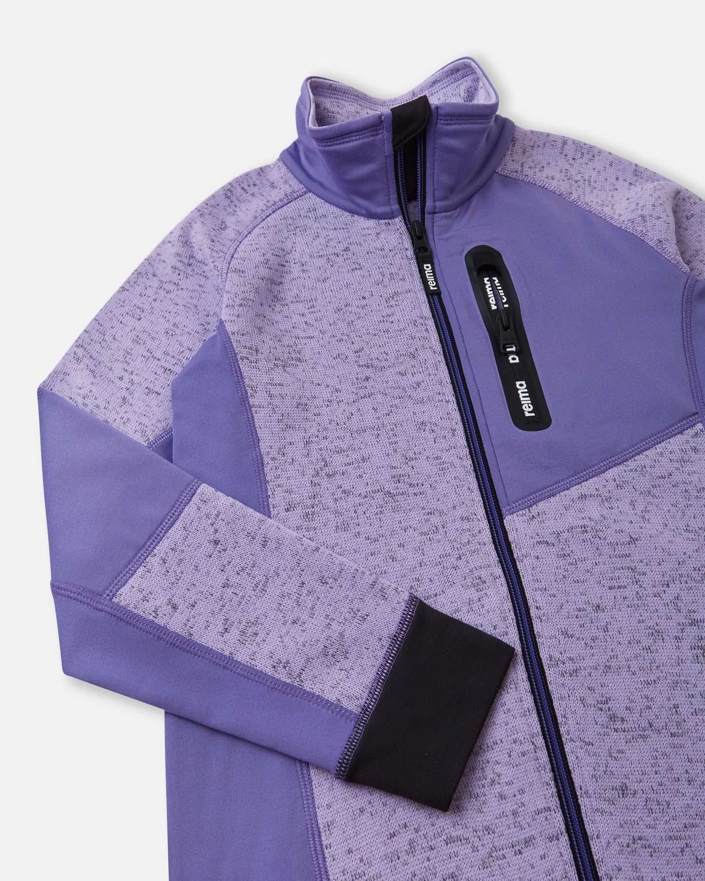 Close-up of the secure zippered chest pocket on the blooming lilac Reima Laskien kids' fleece jacket, featuring a protective high collar and anti-chafe chin guard.