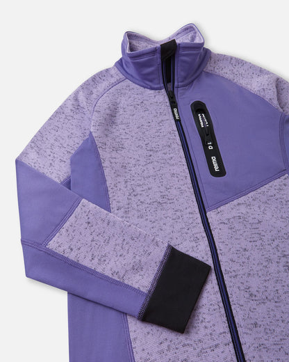 Close-up of the secure zippered chest pocket on the blooming lilac Reima Laskien kids' fleece jacket, featuring a protective high collar and anti-chafe chin guard.