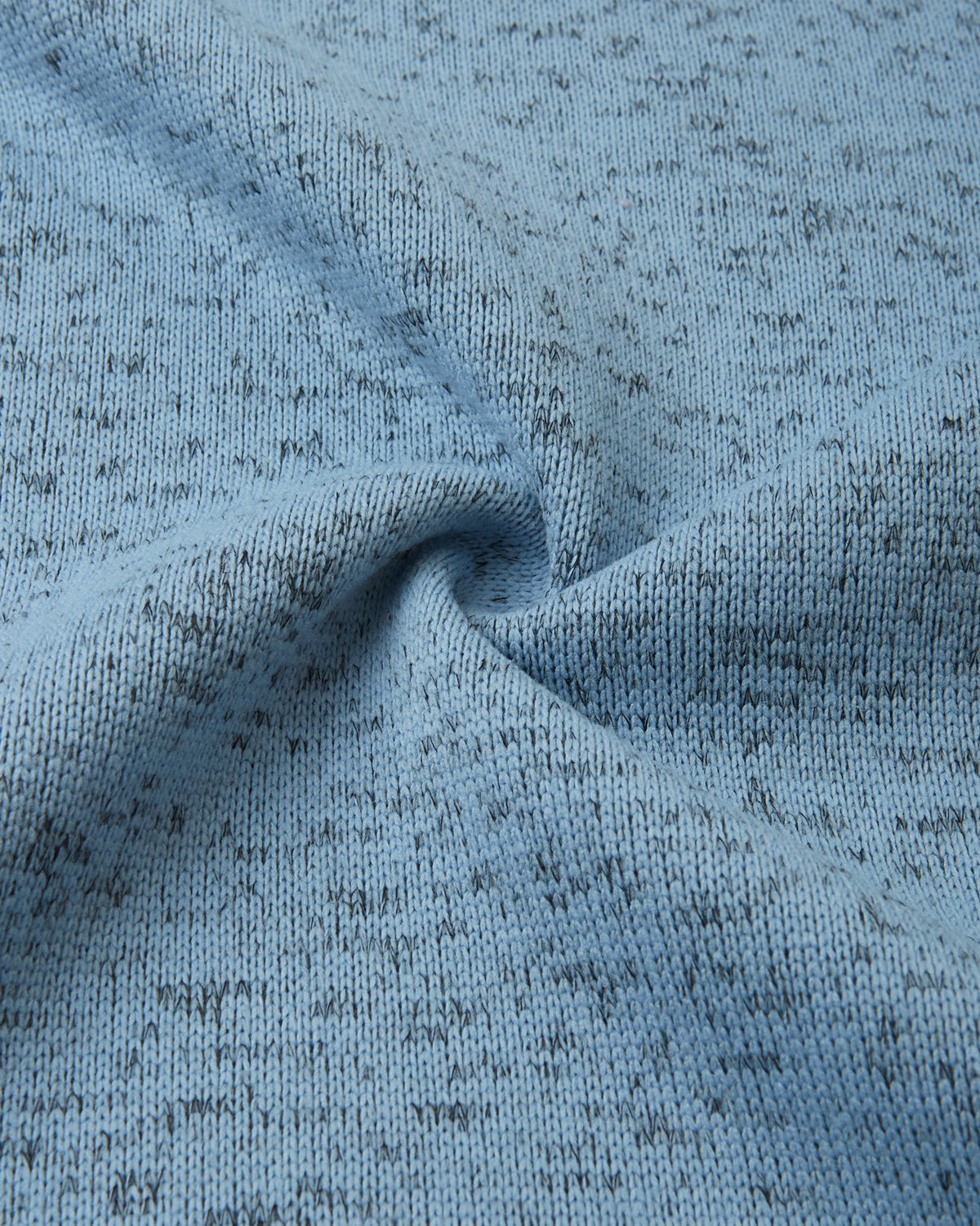 Macro close-up of the breathable, soft-brushed fleece knit fabric on the Reima Laskien kids' jacket, demonstrating its premium warmth and moisture-wicking properties.