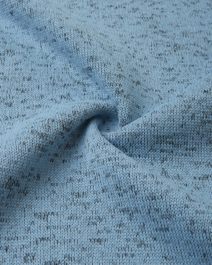 Macro close-up of the breathable, soft-brushed fleece knit fabric on the Reima Laskien kids' jacket, demonstrating its premium warmth and moisture-wicking properties.
