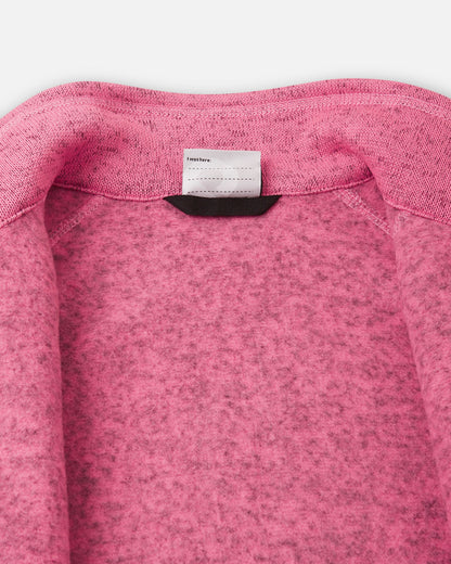 Detail view of the inner neck label on the soft coral Reima Laskien kids' fleece jacket, featuring space for a name tag and highlighting the soft, warm fleece lining.
