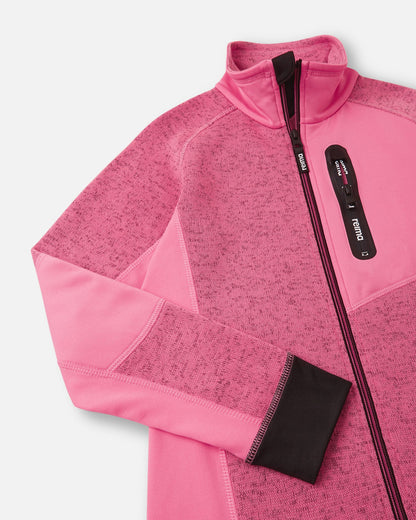 Close-up of the secure zippered chest pocket on the soft coral Reima Laskien kids' fleece jacket, featuring a black zipper pull and reinforced trim.
