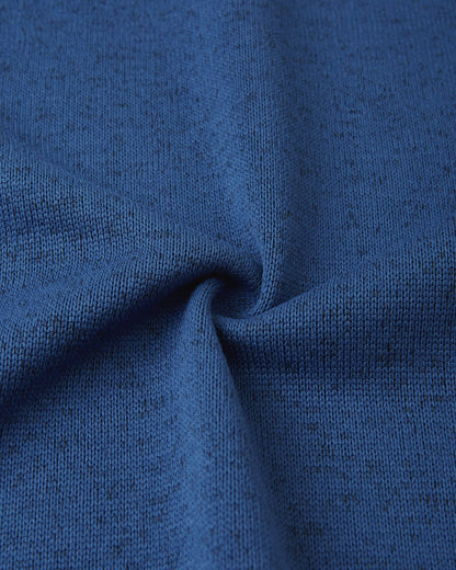 Close-up texture of the twilight blue Reima Liukuen kids' fleece jacket fabric, demonstrating the breathable, moisture-wicking properties of the sweater-knit material.