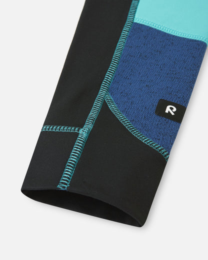 Detailed view of the durable black reinforced sleeve cuff on the twilight blue Reima Liukuen kids' fleece jacket, complete with a high-visibility Reima logo tag.