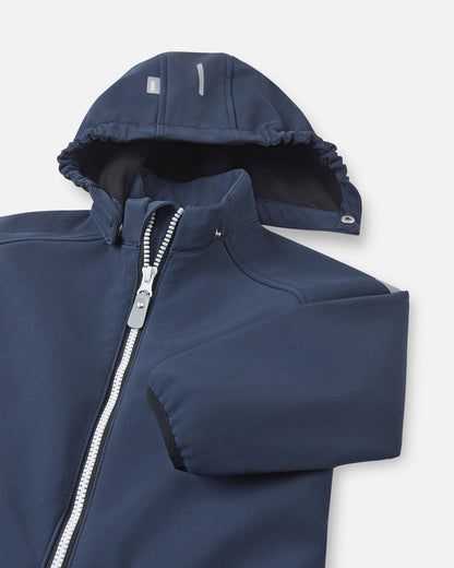 Close-up of the detachable hood and high stand-up collar on the navy Reima Mjosa kids' softshell suit, showing the cozy fleece lining and safe snap-button attachment system.