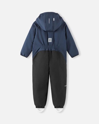 Back view of the navy blue Reima Mjosa kids' softshell overall, highlighting the flexible elastic waist for a comfortable fit, reinforced black seat panels, and a prominent reflective safety patch.
